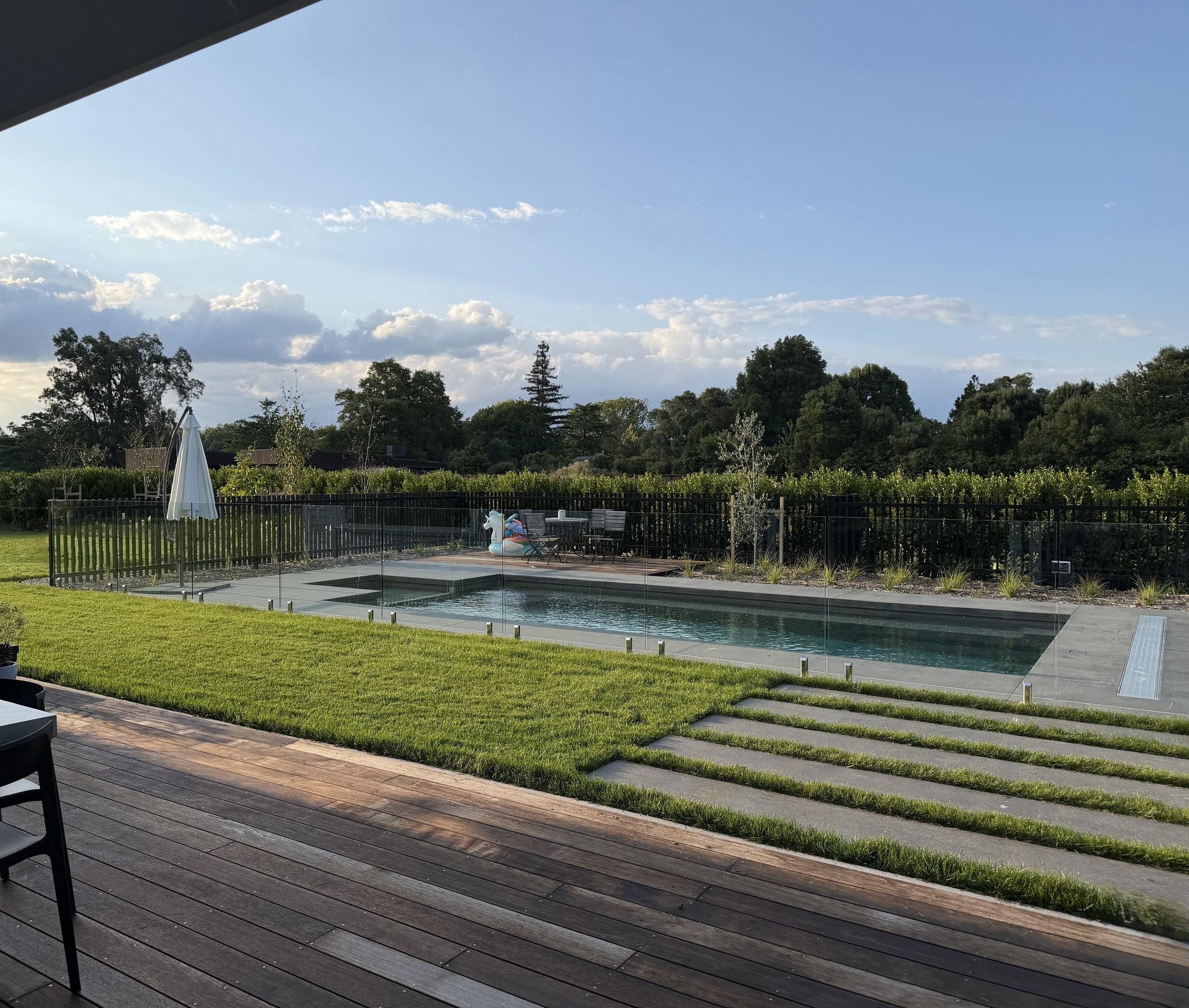 Modern poolside landscape design at dusk
